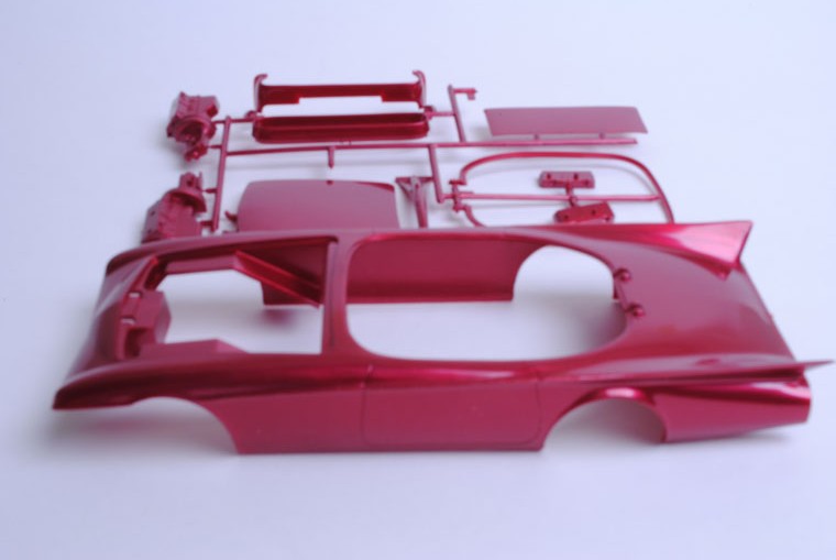 A very few of the parts packaged in the original box were molded in a bright pearl red plastic. The color was beautiful, but the color couldn’t be injected evenly meaning that there were darker “streaks” in the color which was determined to be unacceptable. 